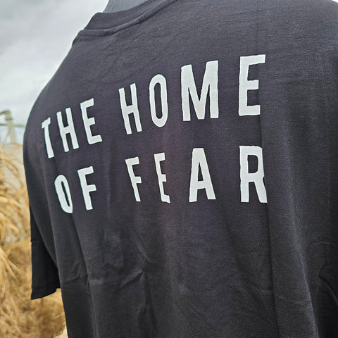 A closer view of the printed text, it is white and says "The Home of Fear"
