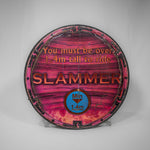 A round wooden sign with the Slammer logo in the middle and advice "you must be over 1.4m tall to ride" above. The print is sun-bleached so is a pink/red tone