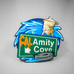 A shaped sign with the Cal Amity Cove logo on the bottom half and the water tower and a splash at the top.