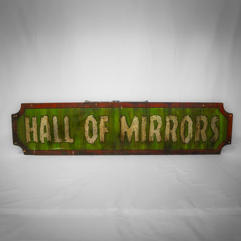 A landscape rectangular sign with indents on each corner. The middle is an apple green colour with the words Hall of Mirrors in white across it. The border is deep red.