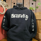 A black oversized hoody with slightly off white text on the front which reads Believer. The arms have runes from within the ride printed down them. There is a pocket on the front of the hoody in the stomach region.