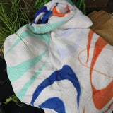 A white blanket with coloured Thorpe Park patterns on it