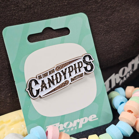 A pin badge with a white background. On top is the word Candypips in a dark bronze colour in vintage font. Above in a smaller font is Big Easy Blvd, and below is Sweeteasy.