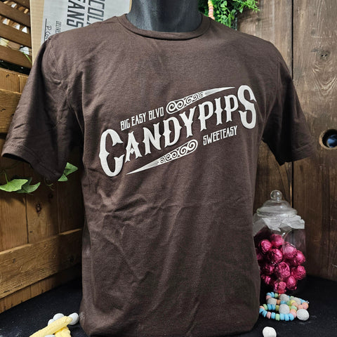 A brown t-shirt with an off-white printed logo across the chest. The logo says Candypips in a vintage style font with smaller font above reading Big East Blvd and underneath the word Sweeteasy.