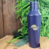 A purple bottle shaped like a cocktail shaker, the Colossus logo is printed on it in a light gold