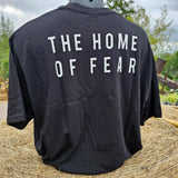 The reverse of the oversized t-shirt, with the words The Home of Fear printed on the black fabric in a white font