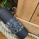 A black metal bottle with white print on the middle. The print is of the runes from inside the ride