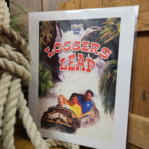 A printed image of a classic Loggers Leap poster. It shows some people in a wooden log boat splashing down at the bottom of a waterfall