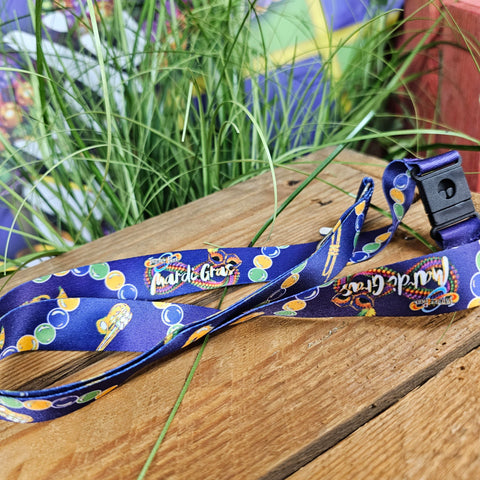A purple lanyard with images of beads and instruments on it