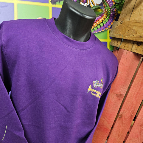 A bright purple sweatshirt with a printed on Mardi Gras logo and trumpet on the chest pocket area