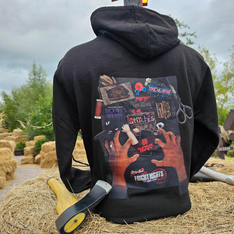 The back of the hoody, it is black fabric and has a graphic on it which is two hands reaching over a workbench for the attraction logos