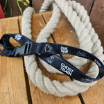 A black lanyard with white imagery printed along it. Towards the bottom is a clip .