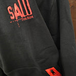 A close up of the embroidered logo and zip pocket