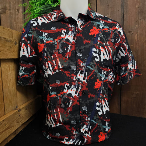 A button up shirt, which is black with printed white SAW logos, and red, grey and blue splashes of colour.