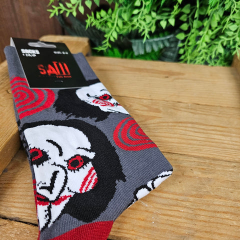 Grey socks, with the Billy doll face and red spirals across them