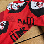 Red socks, with the Billy doll face and dark red spirals and heel details. On the sole is the SAW - The Ride logo in black
