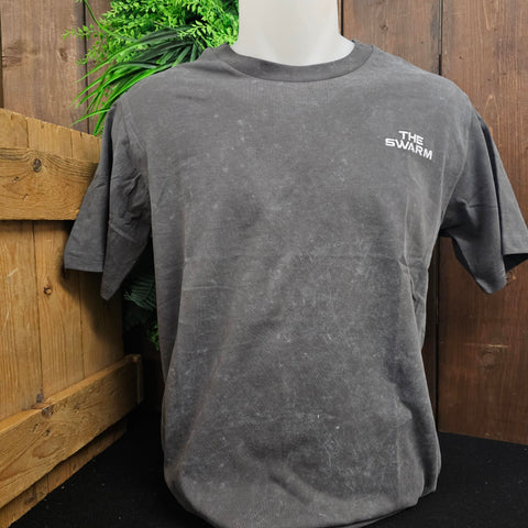A grey acid washed t-shirt, which has caused some lighter patches. There is an embroidered THE SWARM logo in white thread on the chest pocket.