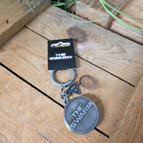 A round keyring with the Swarm logo on the front, there is a symbol key charm too