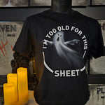 A black t-shirt with a host in the middle and the phrase "I'm Too Old For This Sheet" around it.