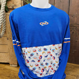 A long sleeved top in royal blue, with a white panel in the torso area with prints of ride artwork on. There are white and orange stripes on the elbows and an small infinity loop logo in the centre of the chest