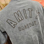 A photograph of the back graphic which is the text Amity Raceway, slightly faded as if it is aged