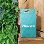 The box that the cards come in, it is teal with a lighter teal pattern running across it. In the middle is a Thorpe Park logo in white.