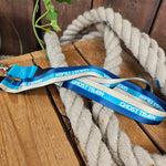 A different angle of the lanyard, showing the three tone (cream, teal, royal blue) stripes which run along the length