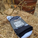 A photograph of a pair of socks. They are black and white with the words fright nights across them. The toes and heel are white.