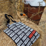 A photograph of the shopper bag, it is black with the words Fright Nights repeated in white across it all, with one in red on the bottom right.