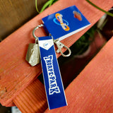 A photo of the keyring, it has a blue strap with the words Thorpe Park on it, and two charms - a metal clip embossed with the logo and a keyring clip