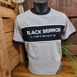 A grey t-shirt with a black stripe across the chest which says "Black Mirror Labyrinth"