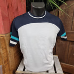 A photograph of a t-shirt with a white body and navy blue stripe across the shoulders