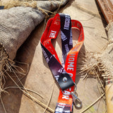 A photograph of a lanyard, the underside is red and says The Home of Fear in a silver text, the other side is black with the Fright Nights logo
