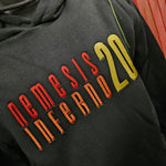 A close up of the embroidered text, the word Nemesis is in red, Inferno in orange and the 20 is in yellow