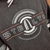 A photo showing a close up of the Stealth logo and tyre print design. The background is black, with grey logo and red detailing